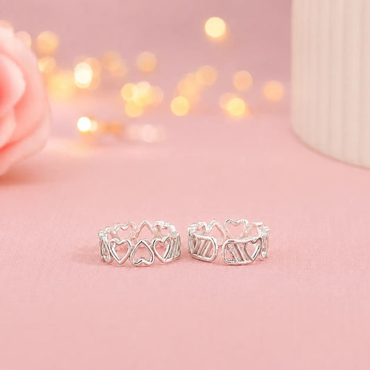 925 Sterling Silver adjustable heart design toe ring pair for women with open heart pattern displayed on a soft pink luxury background