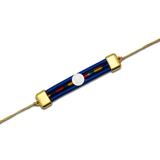 Boys' Rakhi featuring a silver Swashtika centerpiece and a vibrant blue ribbon.