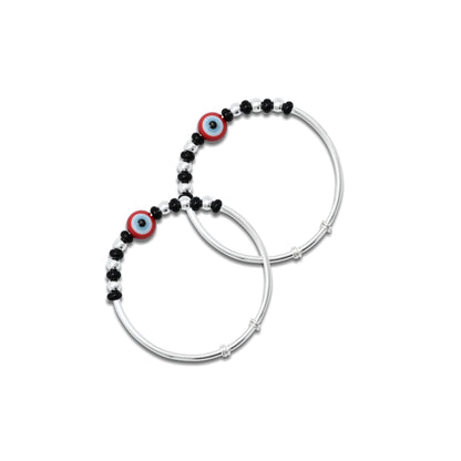 Silver baby kada with black beads and an evil eye design