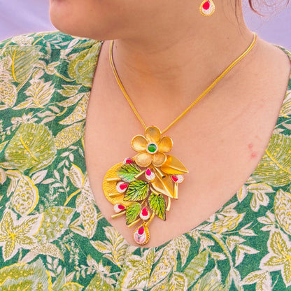 Charming Gold Polish Silver Necklace with Large Flower Center, Gold Leaves, and Pink Gemstones.