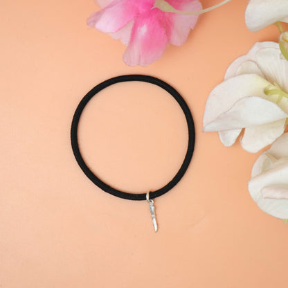 A chic black bracelet with a silver charm