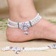 Silver anklet adorned with floral motifs and vibrant gems.