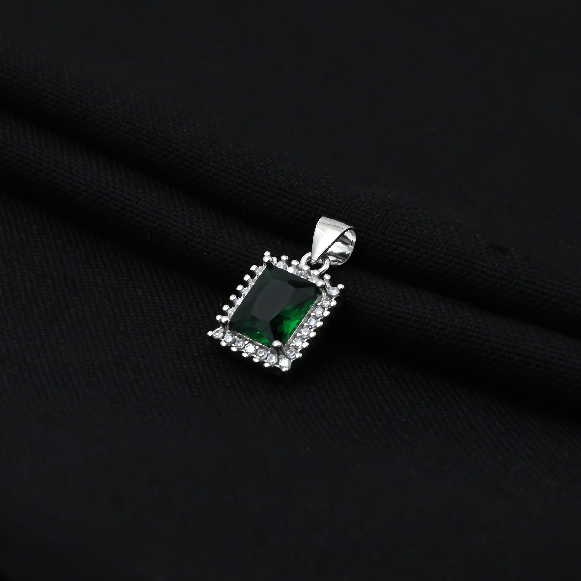 Charming silver pendant with a vibrant green gemstone, designed in a rectangular form for girls