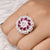 Stylish silver ring adorned with pink flower-shaped gem.