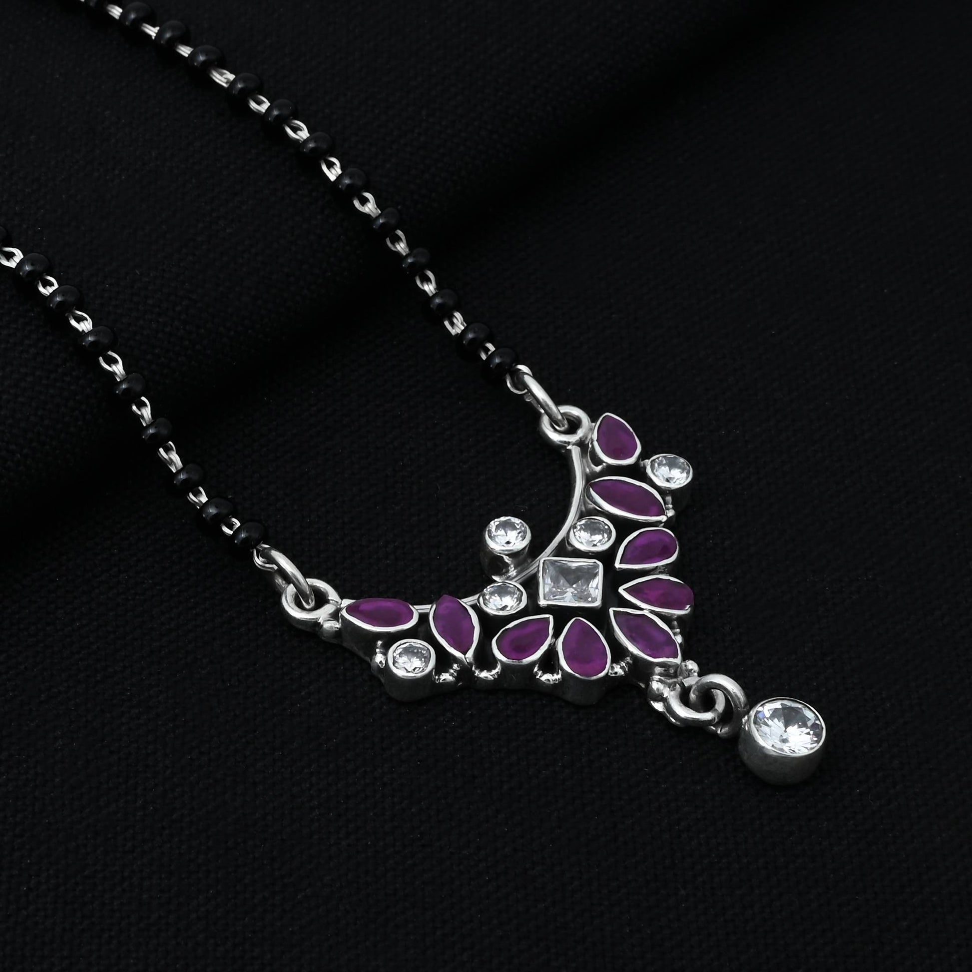 Timeless sterling silver mangalsutra adorned with a vibrant pink gemstone in a unique design