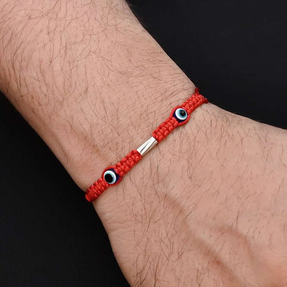 Elegant Rakhi with two purple evil eyes in silver, ideal for boys