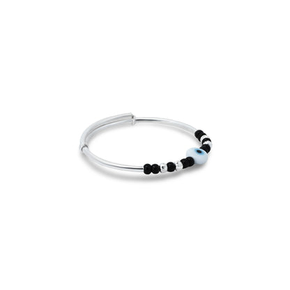 Cute silver kada anklet for babies, adorned with a blue evil eye and black and silver bead accents