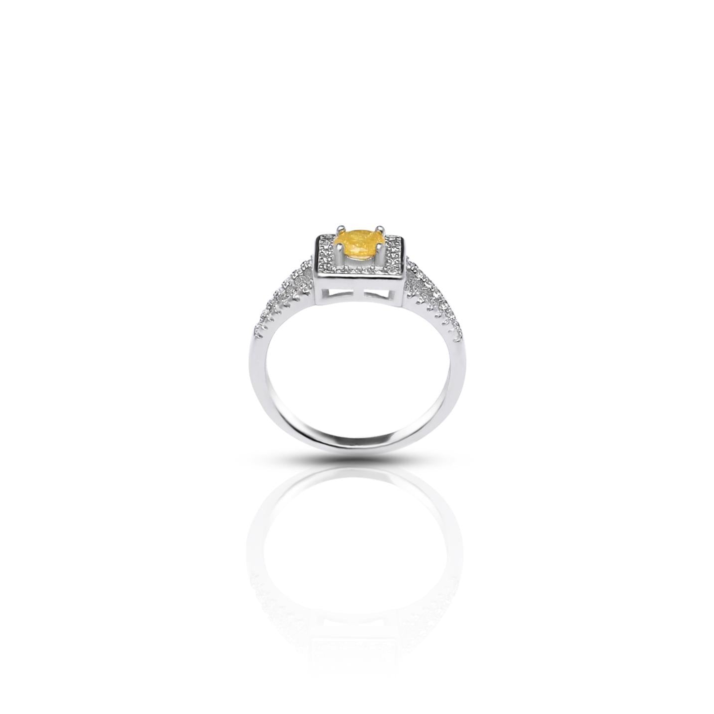 Close-up of a 925 silver ring with a golden yellow gem surrounded by a halo design for girls.