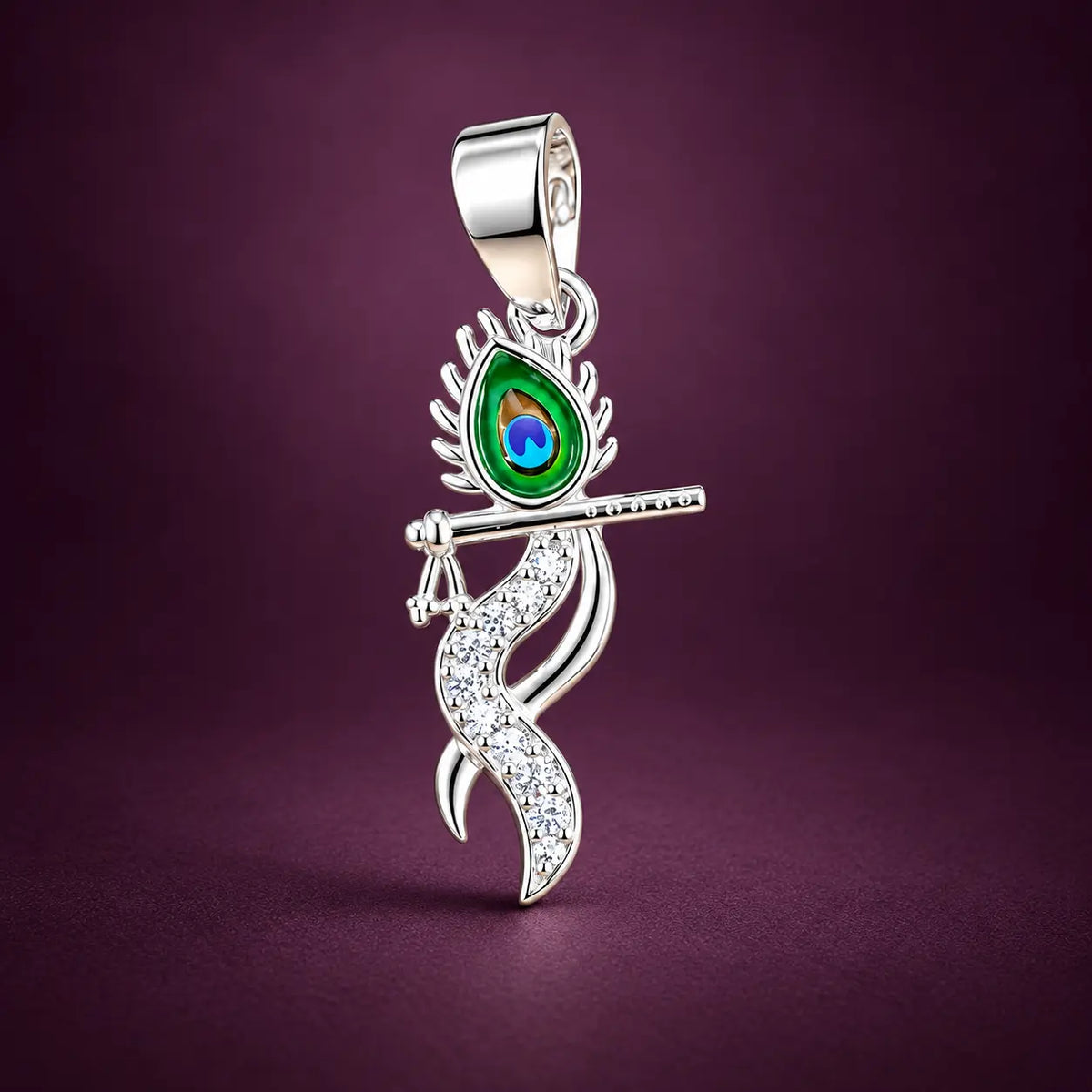 Silver Krishna flute pendant with colorful peacock feather design and sparkling white stones on a champagne-gold background