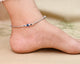 Silver anklet for girls featuring a center blue and black evil eye design, offering a protective and stylish touch.