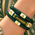 Dark Green Traditional Designer Bangles with Golden Swastika & Peacock Motifs