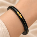 Gold Center Swathik Design Black Bangles