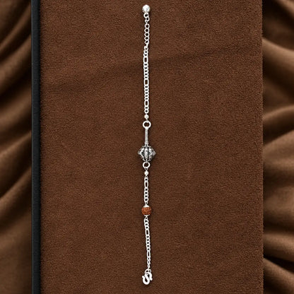 Hanuman Ji Ki Ghota silver bracelet with decorative silver chain and brown Rudraksha-style bead on a brown jewellery display