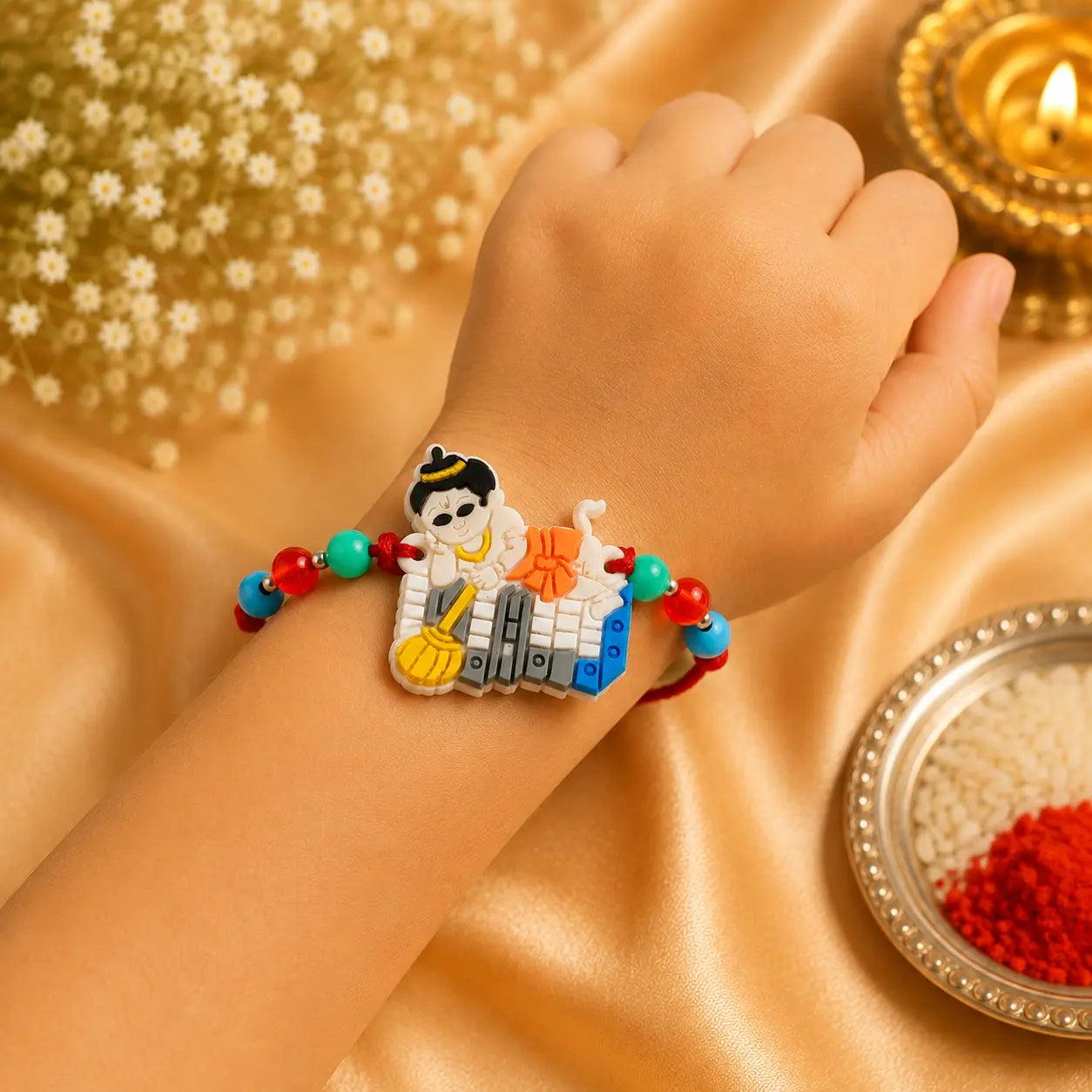 Colorful Hanuman Rakhi with Bal Hanuman design and multicolor beads on beige cushion