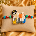 Colorful Hanuman Rakhi with Bal Hanuman design and multicolor beads on beige cushion