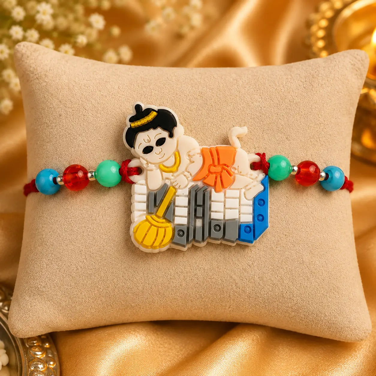 Colorful Hanuman Rakhi with Bal Hanuman design and multicolor beads on beige cushion