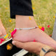 Modern Silver Anklet Featuring Red and Green Cylindrical Stones.