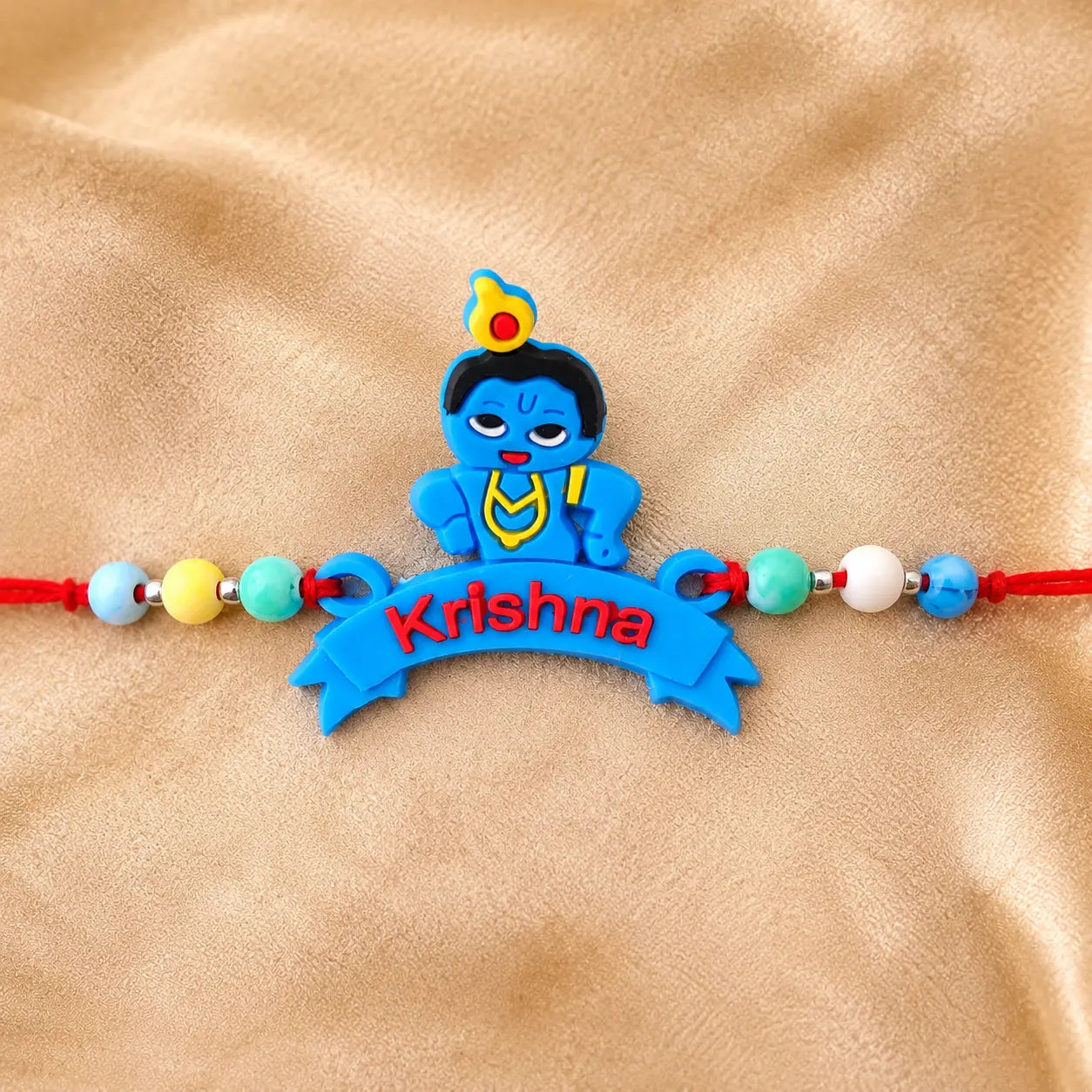 Cute Krishna Rakhi for kids with colorful beads and red thread