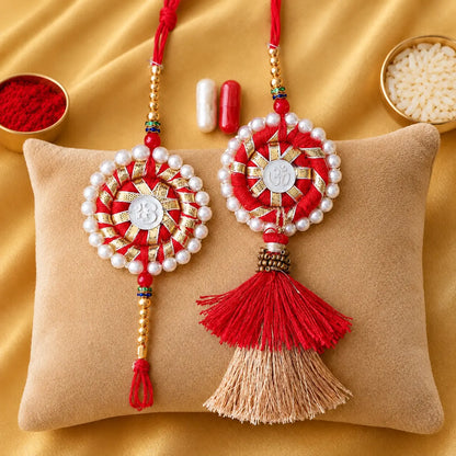 Traditional Om Swastik Pearl Lumba Rakhi Set for Bhaiya Bhabhi with white pearl border, red thread, golden beads and decorative Lumba tassel for Raksha Bandhan.