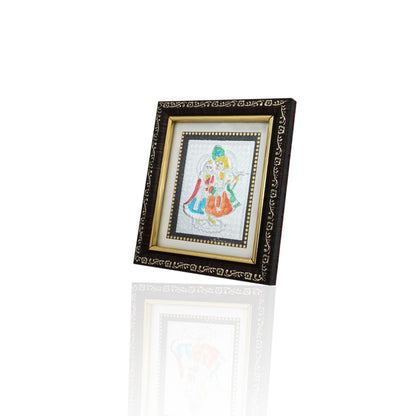 This silver picture frame features a stunning depiction of the selfless love shared between Radha and Krishna. Crafted with intricate detail, it serves as a beautiful reminder of devotion and companionship. 