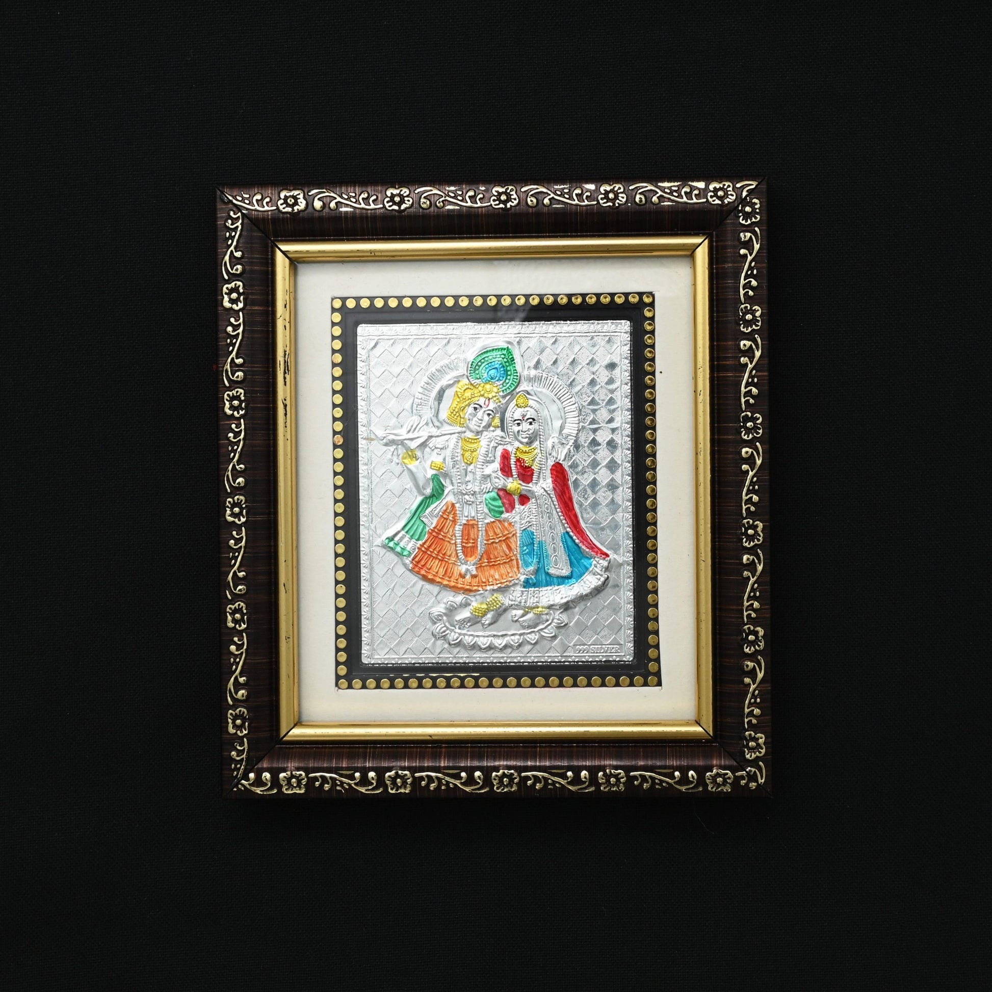 This silver picture frame features a stunning depiction of the selfless love shared between Radha and Krishna. Crafted with intricate detail, it serves as a beautiful reminder of devotion and companionship. 