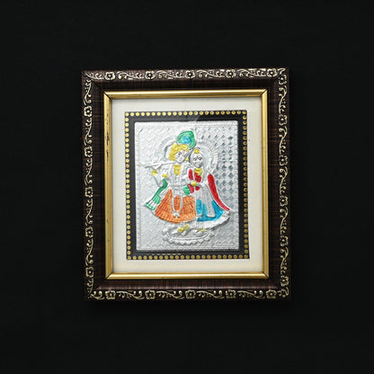 This silver picture frame features a stunning depiction of the selfless love shared between Radha and Krishna. Crafted with intricate detail, it serves as a beautiful reminder of devotion and companionship. 