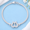 Silver Trishul Bracelet with stone-studded Shiva design on a pastel blue background