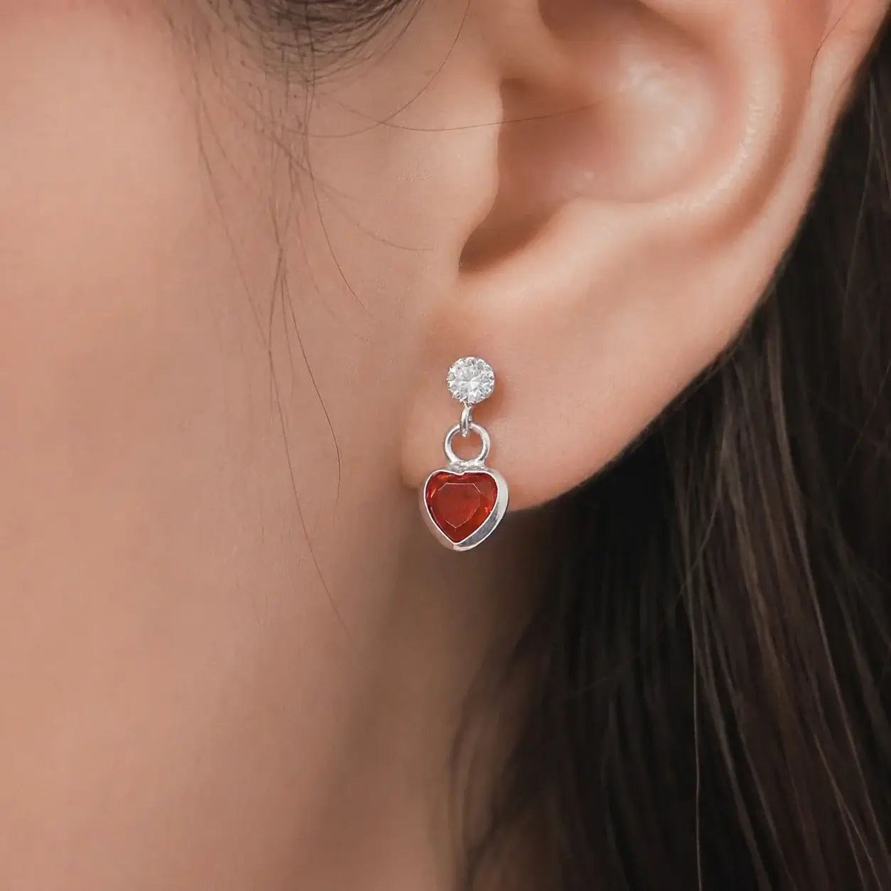 Silver black heart drop stud earrings with sparkling Cubic Zirconia stones and polished silver-tone finish for women displayed on a jewelry card.