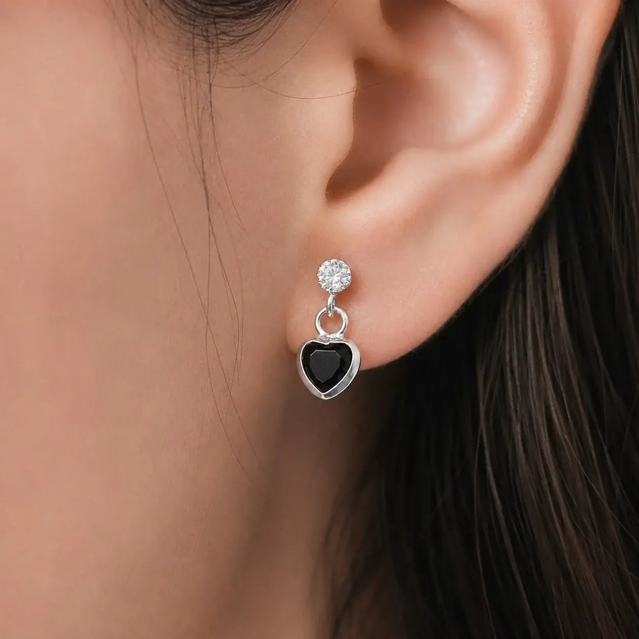 Silver black heart drop stud earrings with sparkling Cubic Zirconia stones and polished silver-tone finish for women displayed on a jewelry card.