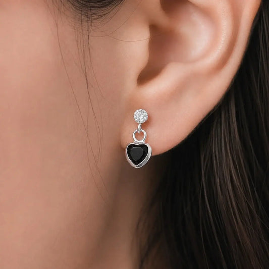 Silver black heart drop stud earrings with sparkling Cubic Zirconia stones and polished silver-tone finish for women displayed on a jewelry card.