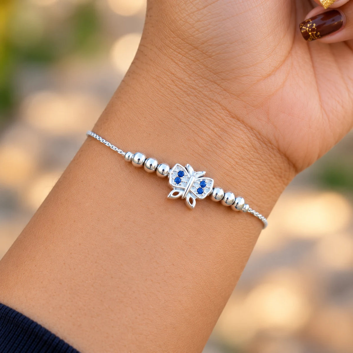 Silver butterfly bracelet with blue stones