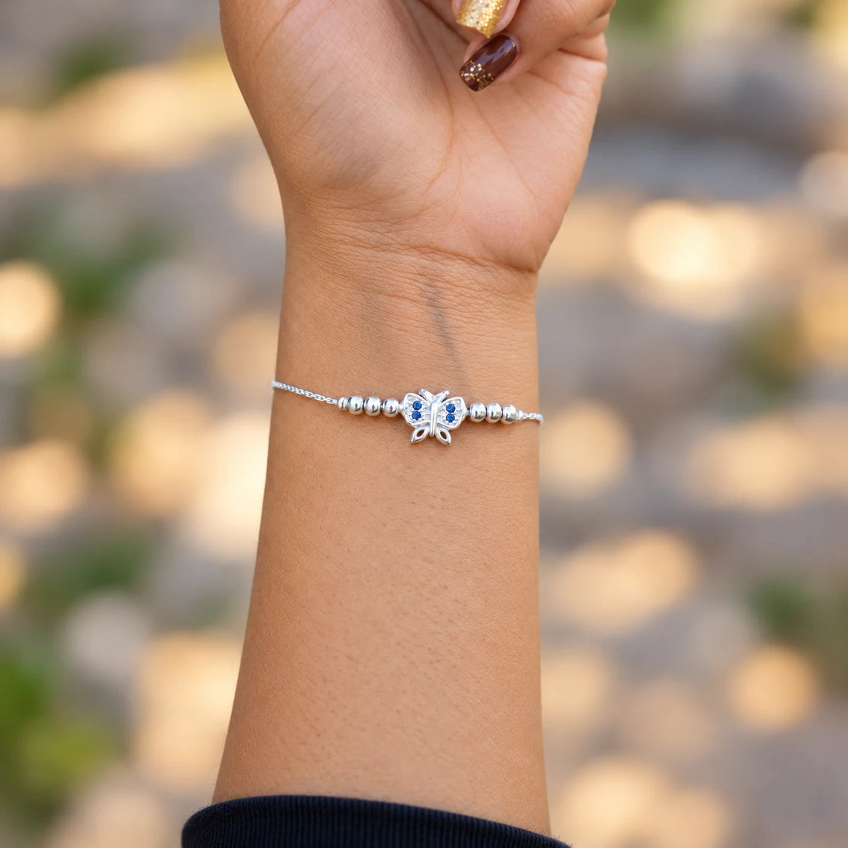 Silver butterfly bracelet with blue stones