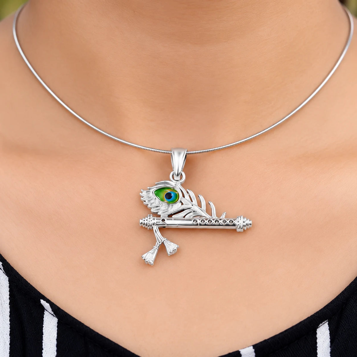Silver Krishna flute peacock feather pendant with green blue and golden enamel detailing