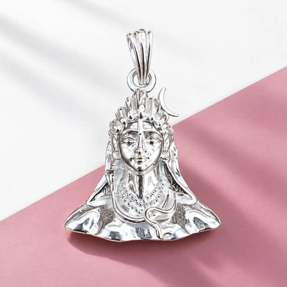 Silver Lord Shiva face pendant with crescent moon and detailed polished silver design on a warm beige background