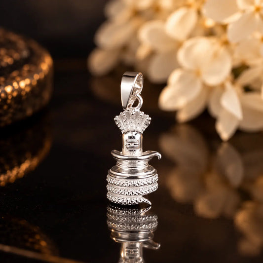 Silver Shivling pendant with cobra hood and coiled Naag design on a dark brown textured background