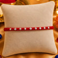 Silver Small Flower Design Beads with Red Thread Rakhi for Boys