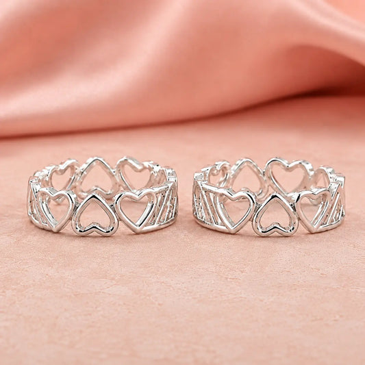 925 Sterling Silver adjustable heart design toe ring pair for women with open heart pattern displayed on a soft pink luxury background