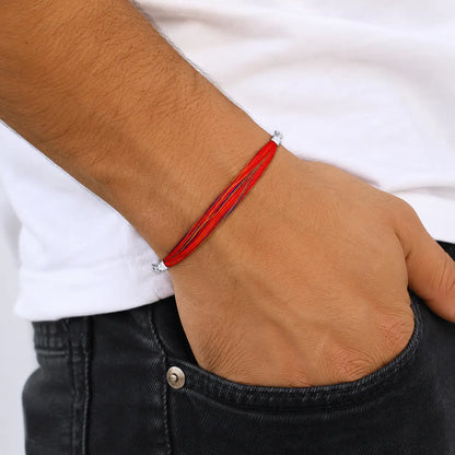 Traditional red and yellow Moli Kalava sacred thread tied on a man's wrist