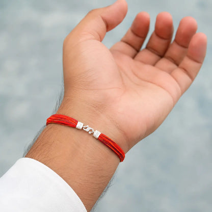 Traditional red and yellow Moli Kalava sacred thread tied on a man's wrist