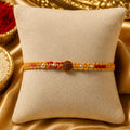 Traditional red Rudraksha Rakhi with natural Rudraksha beads and silver-tone beads