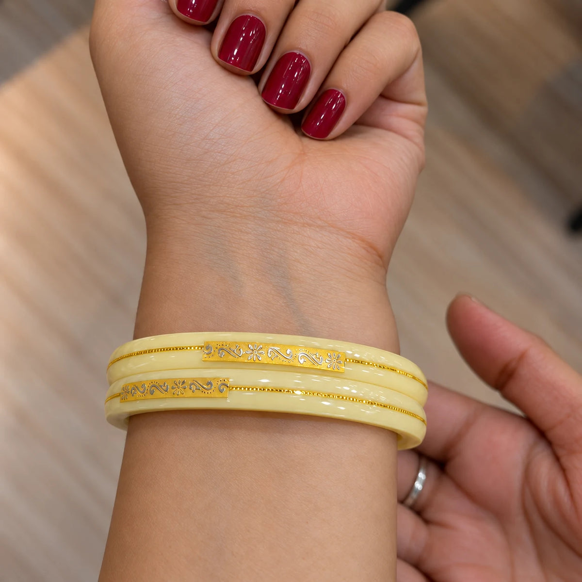 Yellow Designer Bangles with Elegant Golden Floral & Swastika Motifs