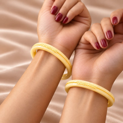 Yellow Designer Bangles with Elegant Golden Floral & Swastika Motifs