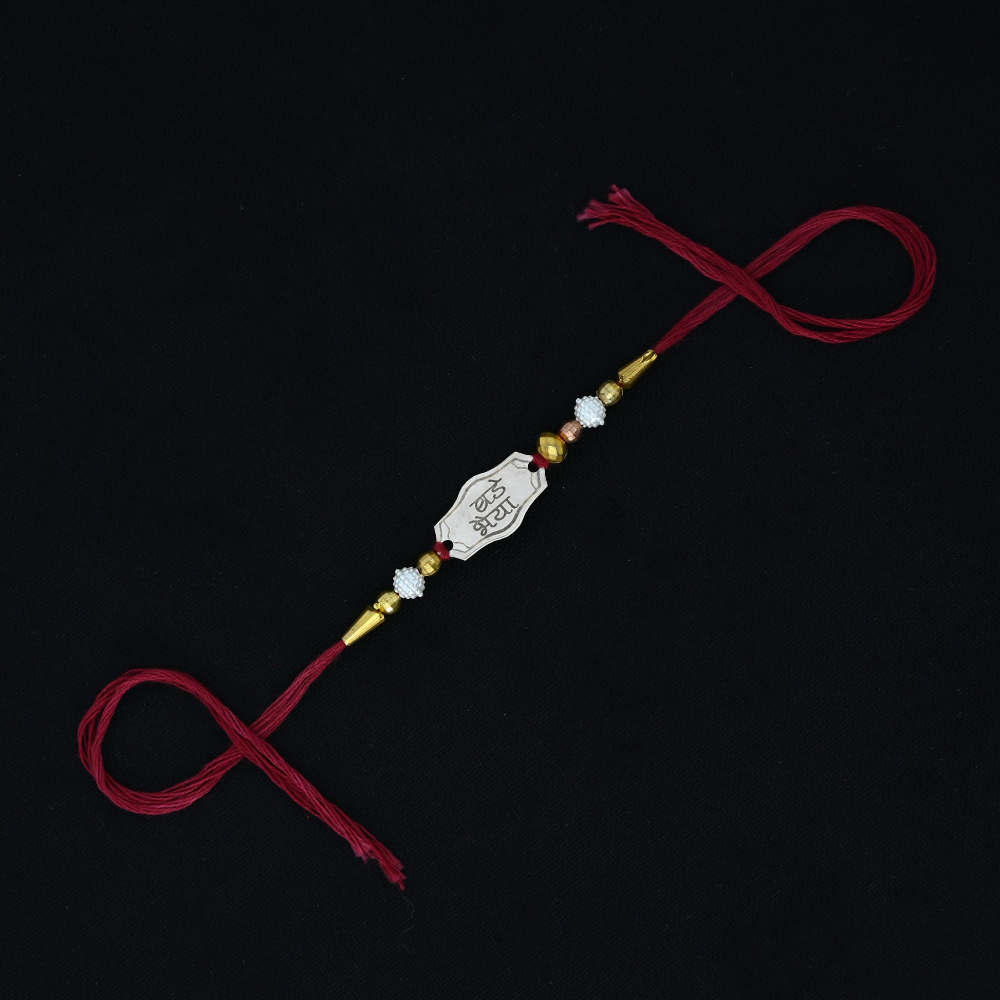 Personalized silver Rakhi with 'Bade Bhaiya' text, designed for boys