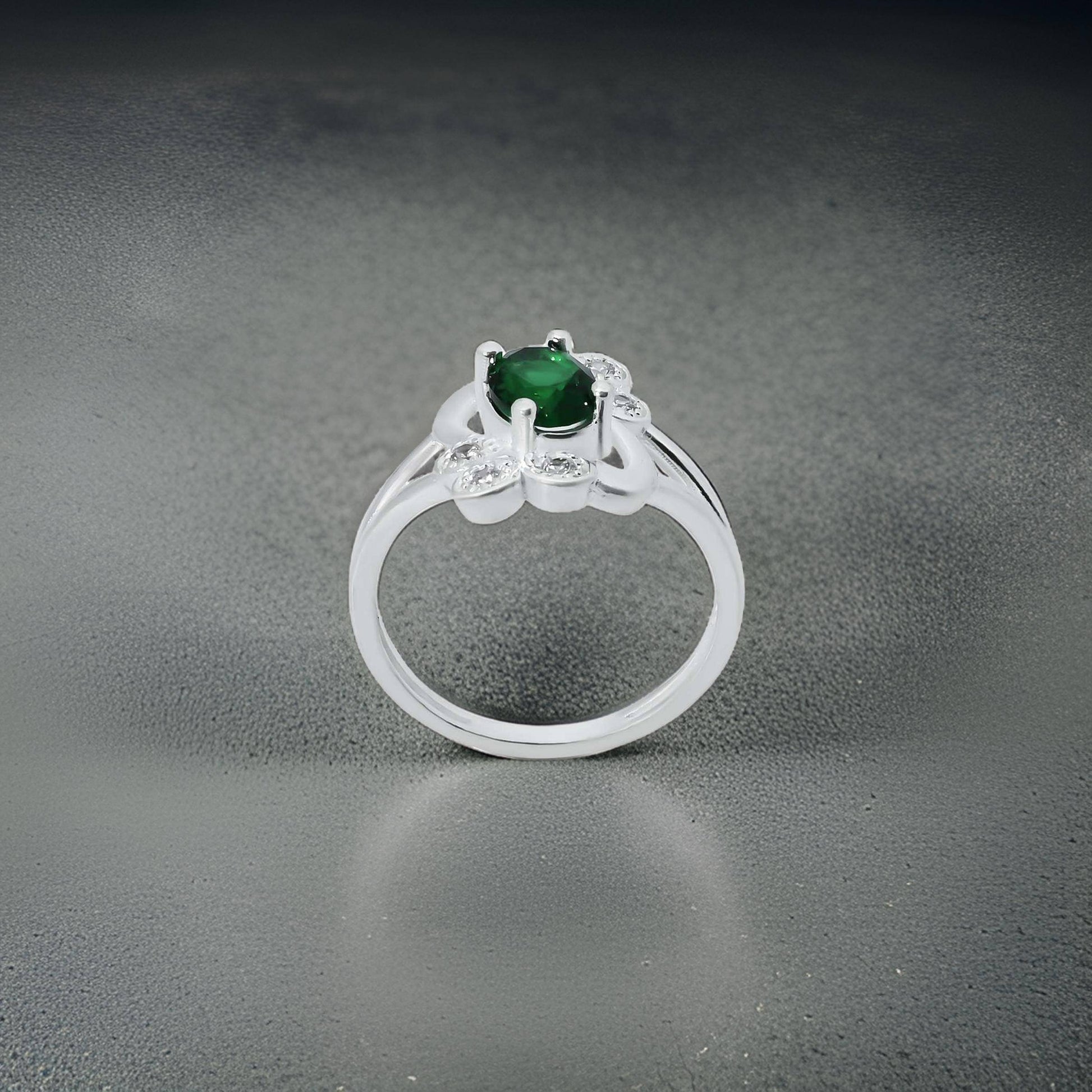 Elegant silver girls' ring with an oval green stone and intricate flower design