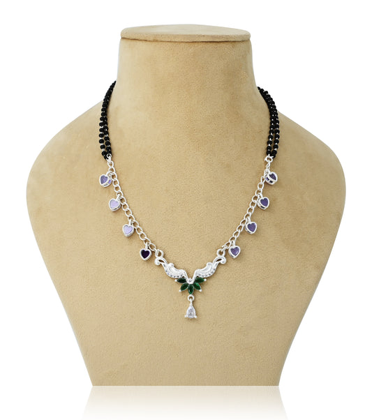 Silver mangalsutra with purple and green gemstones, featuring a stylish wings design