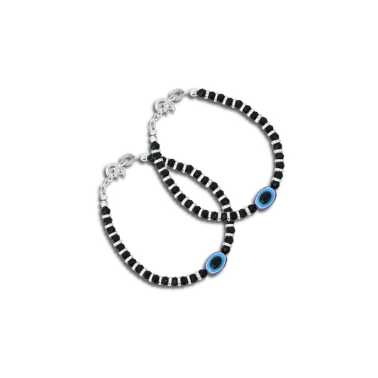 Silver bracelet featuring an oval evil eye charm with black bead accents