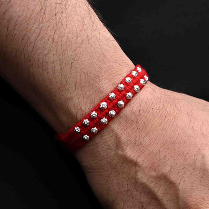 Elegant Rakhi with small flower design beads in silver, ideal for boys.