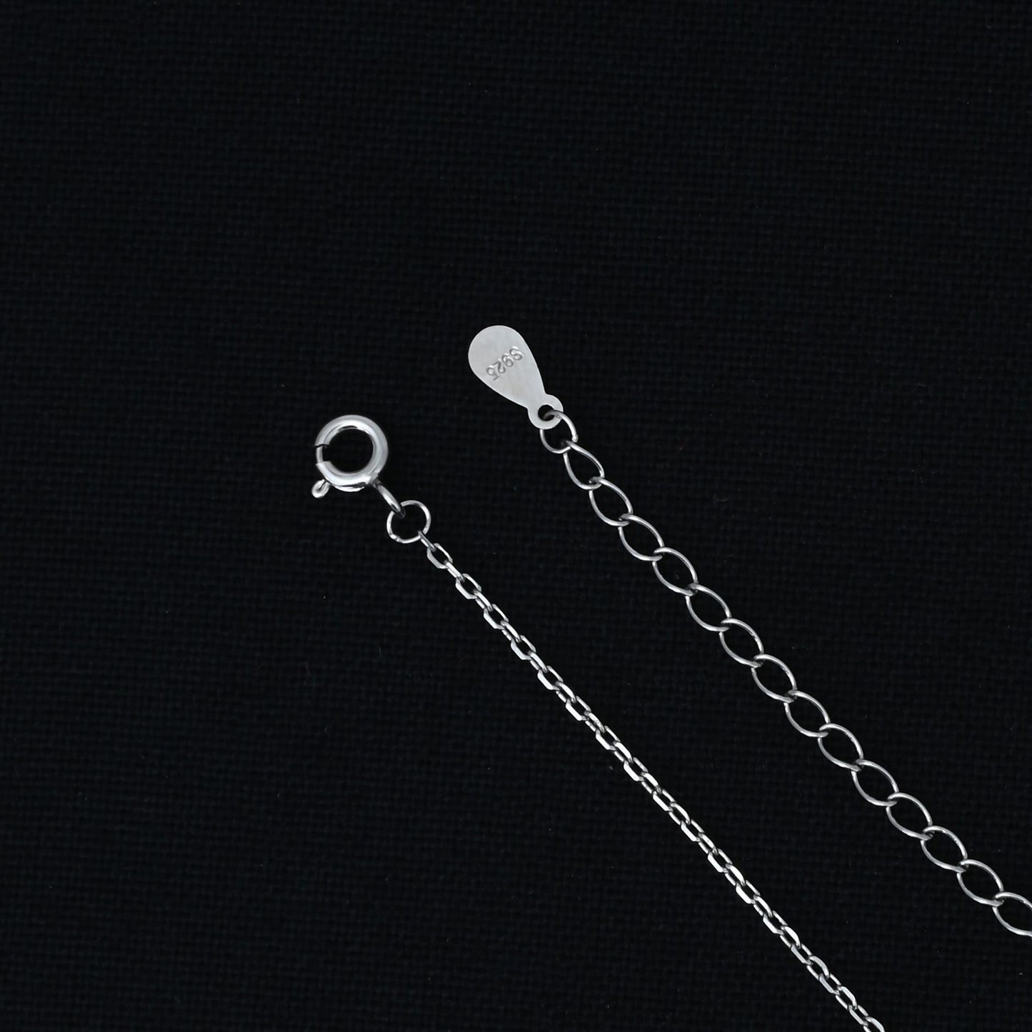 Elegant silver chain with trendy evil eye pendant.