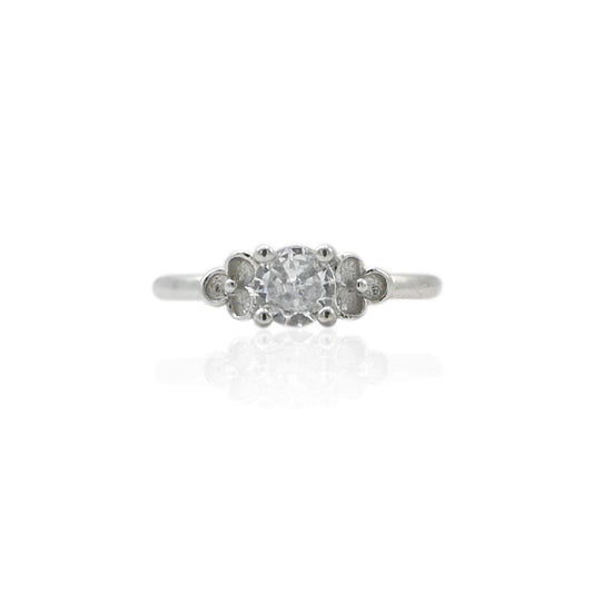 Silver girls' ring featuring a sparkling white gemstone, offering a chic and elegant design.