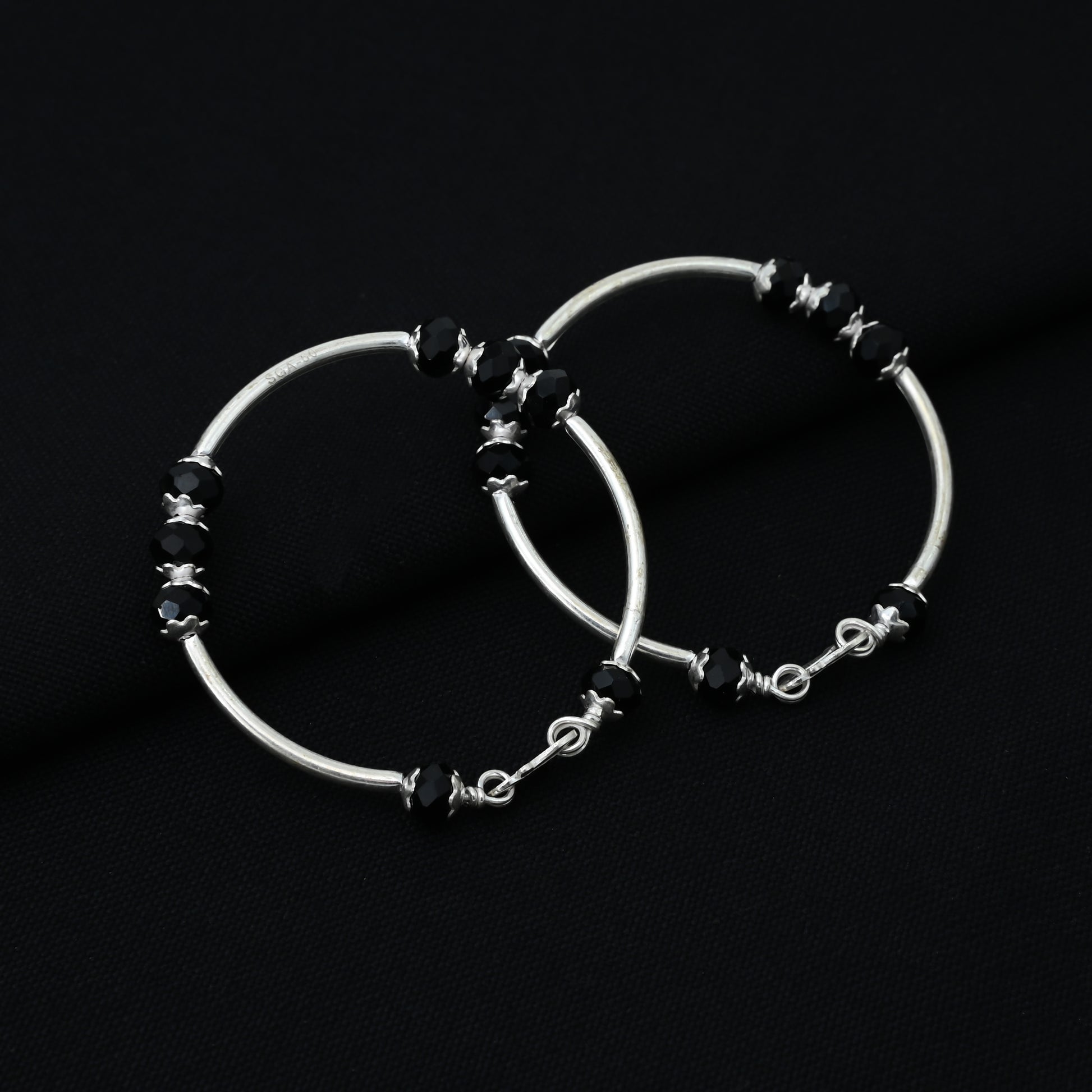 Charming silver baby kada adorned with black beads